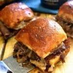 An image of three Guinness beef sliders on a board.
