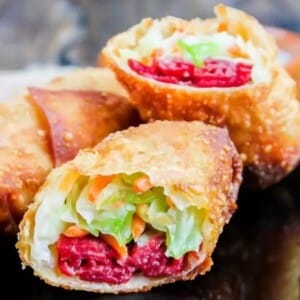 A picture of an Irish egg roll cut in half showing corned beef and cabbage.
