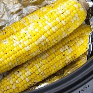 An image of ears of corn stacked in a slow cooker.