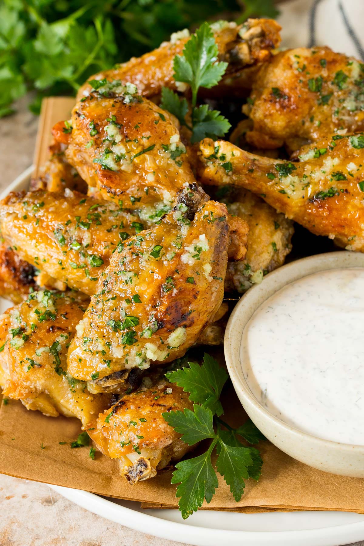 A plate of garlic parmesan wings served with ranch.