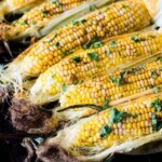 A picture of corn on the cob roasted with chili butter.