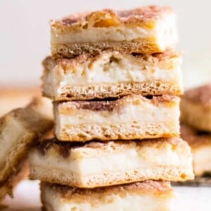 A picture of a stack of sopapilla cheesecake bars.