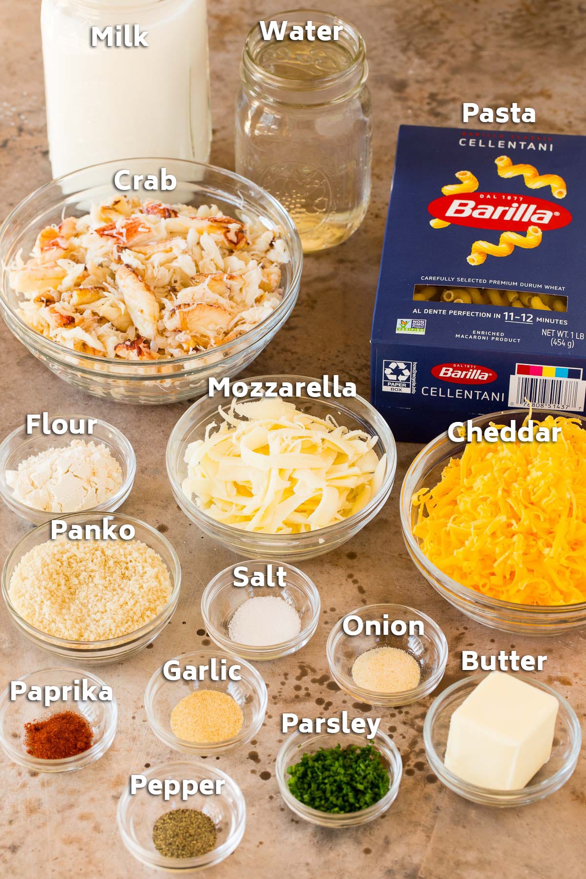 Ingredients including pasta, cheese, crab, milk and spices.