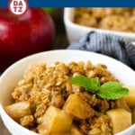 An image of a bowl of the best apple crisp with tender, juicy apples and buttery oatmeal and walnut topping.