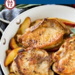 A picture of apple pork chops which are browned in butter and simmered in cider sauce with fresh apples and sage.