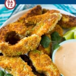 A plate of avocado fries which are slices of avocado that are breaded and lightly fried to crispy golden brown perfection.