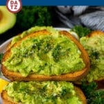 A plate with avocado toast which is fresh avocado mashed with lemon juice, olive oil and seasonings, then spread over sourdough bread.