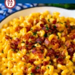 A pan of bacon mac and cheese which is is a one pot dish featuring pasta in a creamy cheese sauce with plenty of bacon.