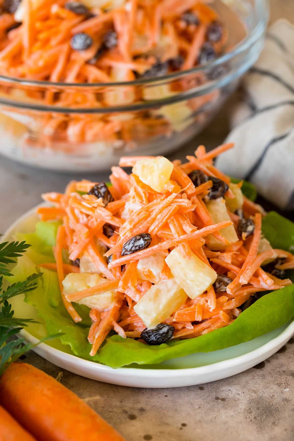 A serving of carrot salad on a lettuce leaf.