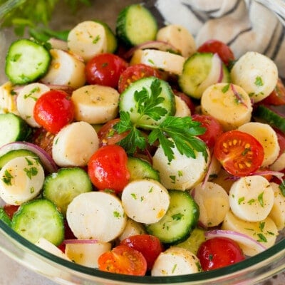 A bowl of hearts of palm salad with parsley on top.