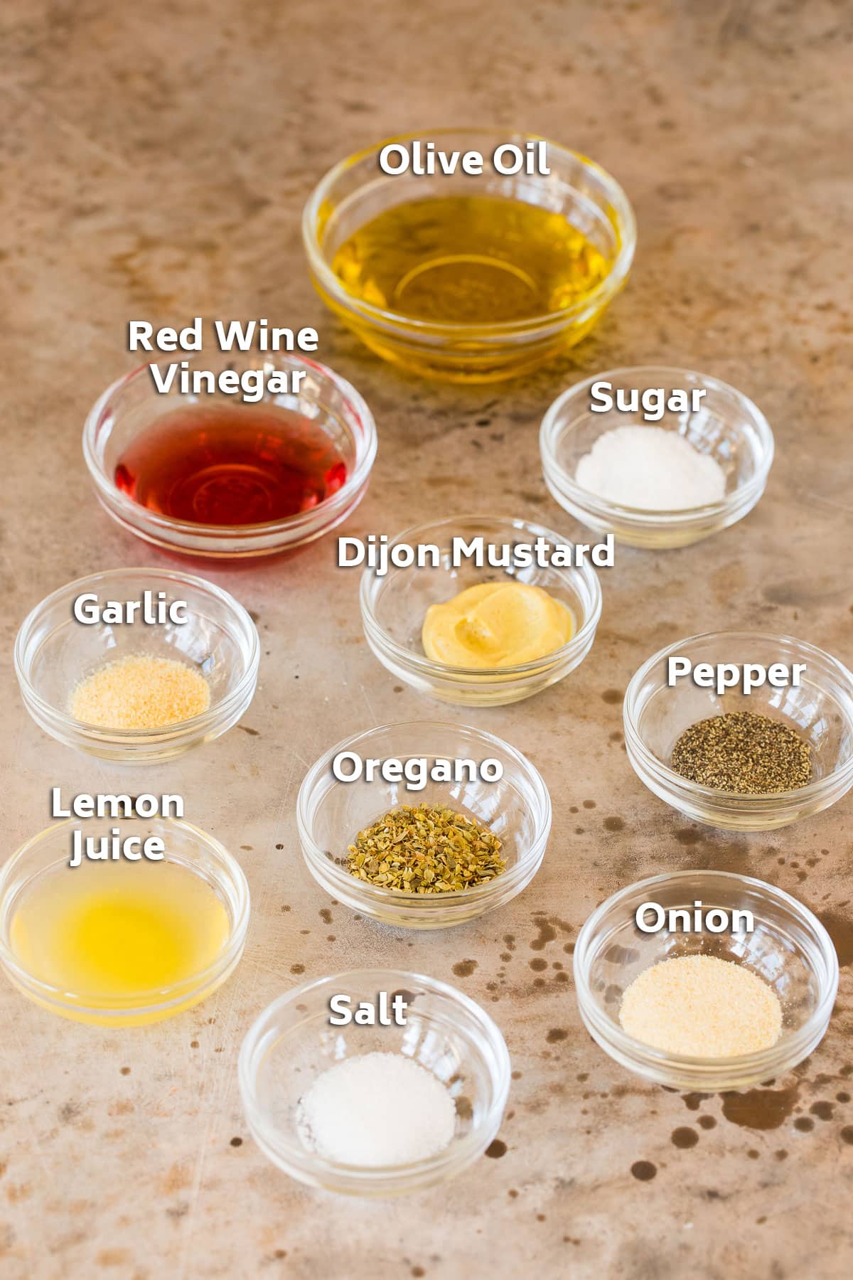 Salad dressing ingredients in bowls.