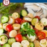 This hearts of palm salad is cherry tomatoes, cucumber, red onion and hearts of palm, all tossed together with fresh herbs in a homemade dressing.