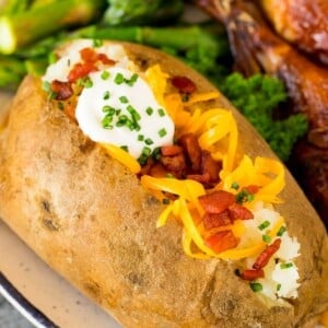 Instant Pot baked potatoes topped with cheese, bacon and sour cream.