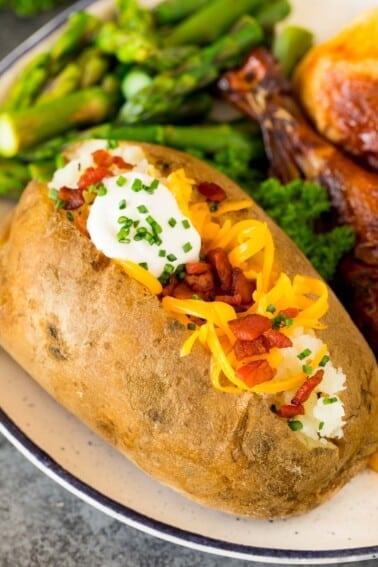 Instant Pot baked potatoes topped with cheese, bacon and sour cream.