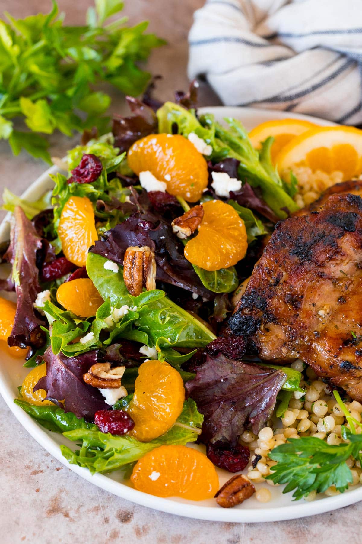 A plate of mandarin orange salad served with chicken.