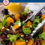 This mandarin orange salad is mixed greens with juicy orange slices, dried cranberries, feta cheese and candied pecans, all tossed in a homemade dressing.