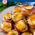 A plate of bacon wrapped scallops which are jumbo scallops coated in a sweet and savory glaze, then broiled to perfection.