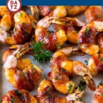 A tray of bacon wrapped shrimp which are jumbo prawns wrapped with bacon and brushed with a sweet and savory glaze, then broiled to perfection.