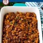 A dish of baked beans with bacon slow cooked in a sweet and savory sauce.
