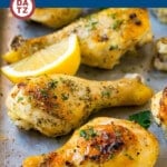 A tray of baked chicken drumsticks marinated in a mixture of olive oil, lemon, garlic and herbs, then baked to golden brown perfection.