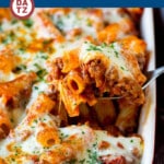 An image of a spoonful of baked rigatoni pasta which is pasta tossed in a flavorful meat sauce, then topped with plenty of cheese and baked until golden brown.