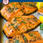 A pan of baked salmon with garlic butter which is baked fish fillets topped with garlic, butter and herbs, then roasted to tender perfection.