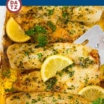 A dish of baked tilapia with garlic butter cooked to tender and flaky perfection.