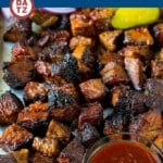 A tray of burnt ends which are tender cubes of brisket coated in BBQ sauce, then cooked until caramelized.