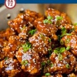 A pan of General Tso's Chicken which is battered crispy chicken pieces tossed in a sweet and spicy sauce.