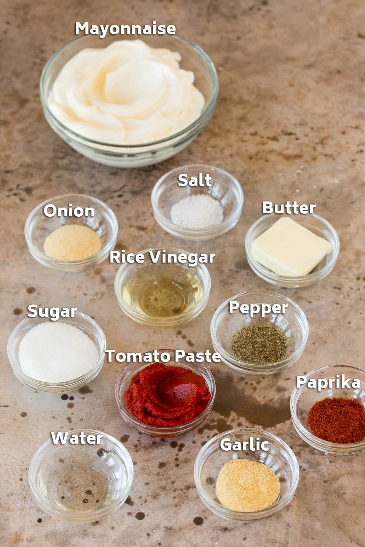Bowls of ingredients including mayonnaise, tomato paste and spices.