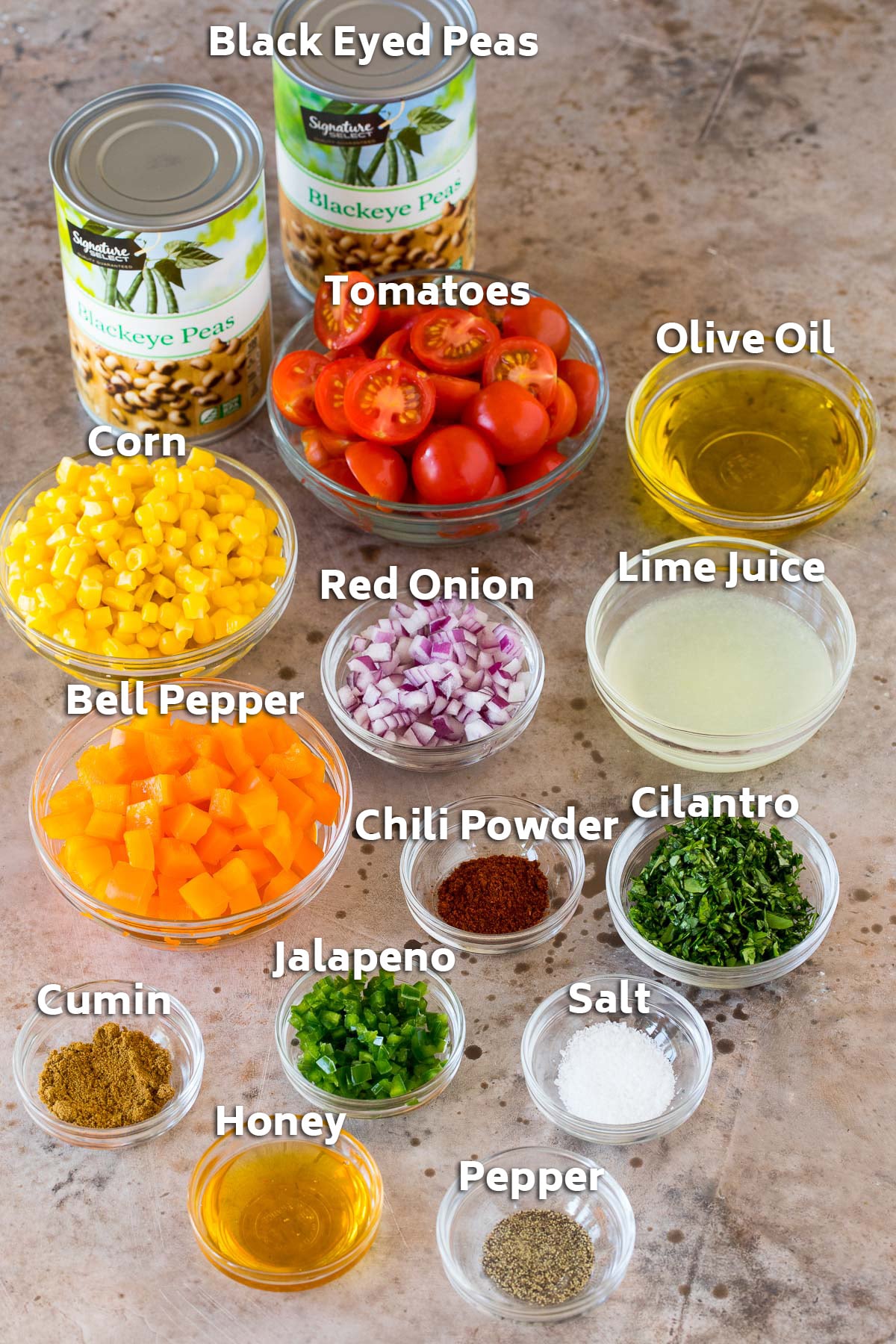 Bowls of ingredients including vegetables, olive oil, lime juice and spices.