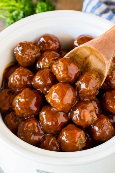 Crockpot BBQ meatballs in a slow cooker with a serving spoon.