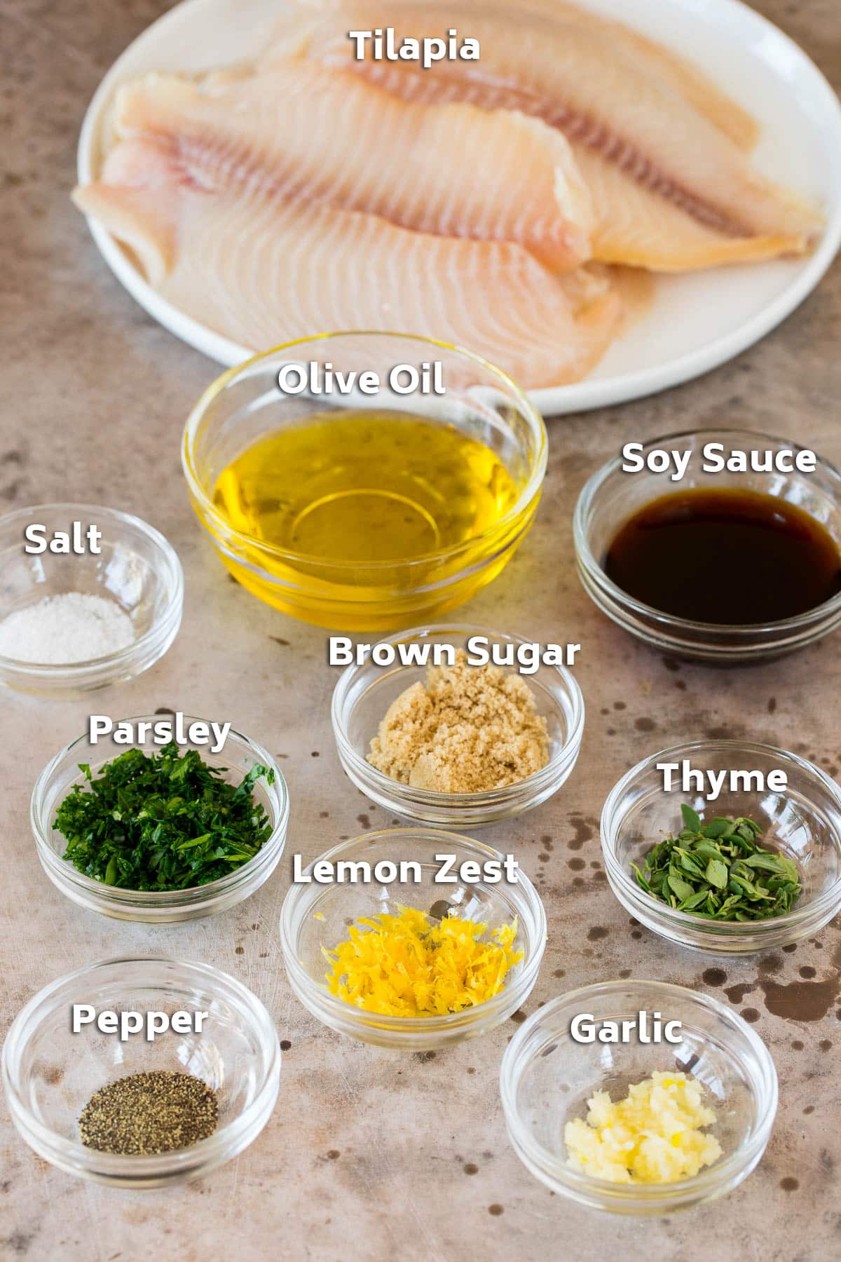 Ingredients including fresh fish, olive oil, soy sauce, herbs and seasonings.
