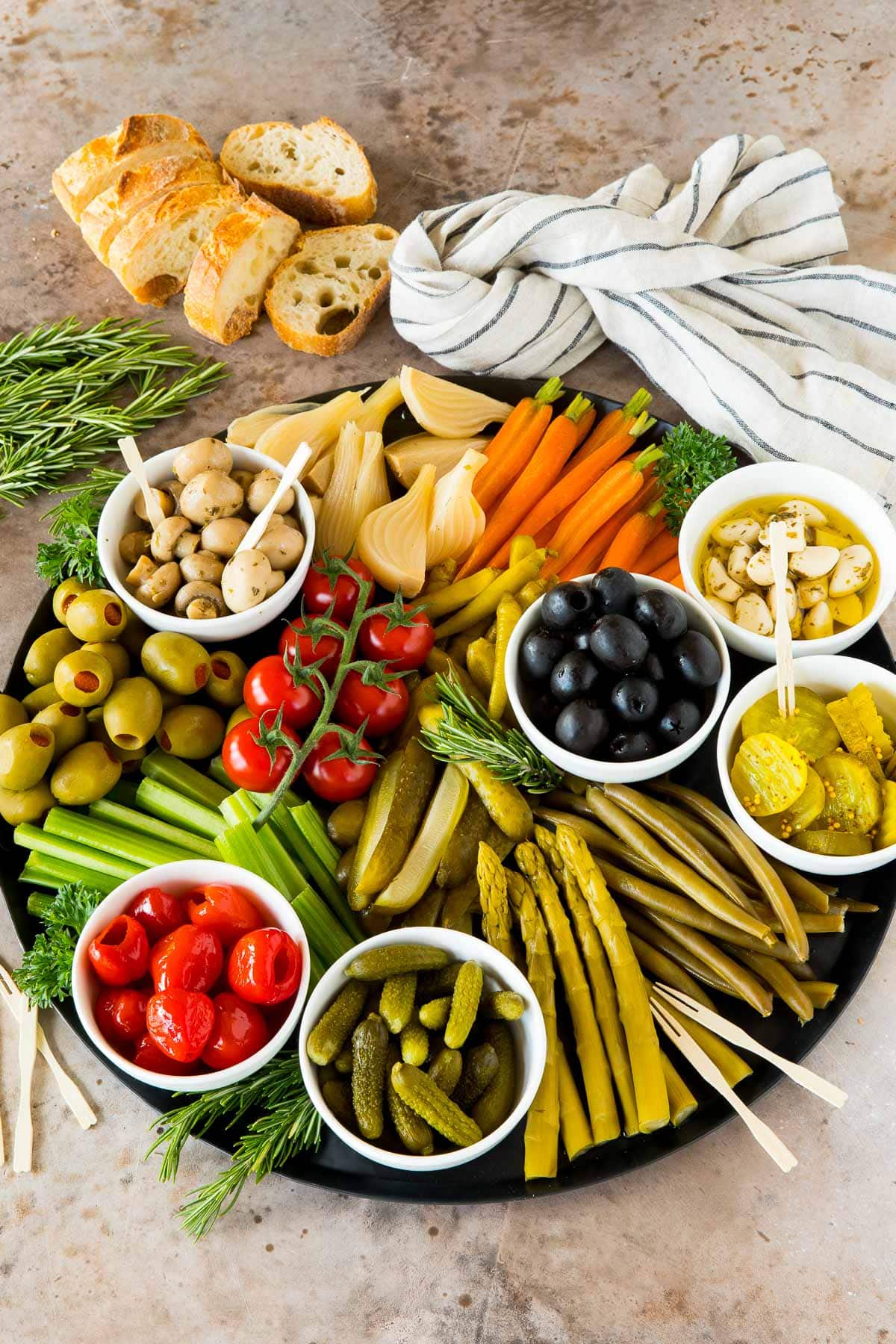 A relish platter with different types of vegetables and olives.