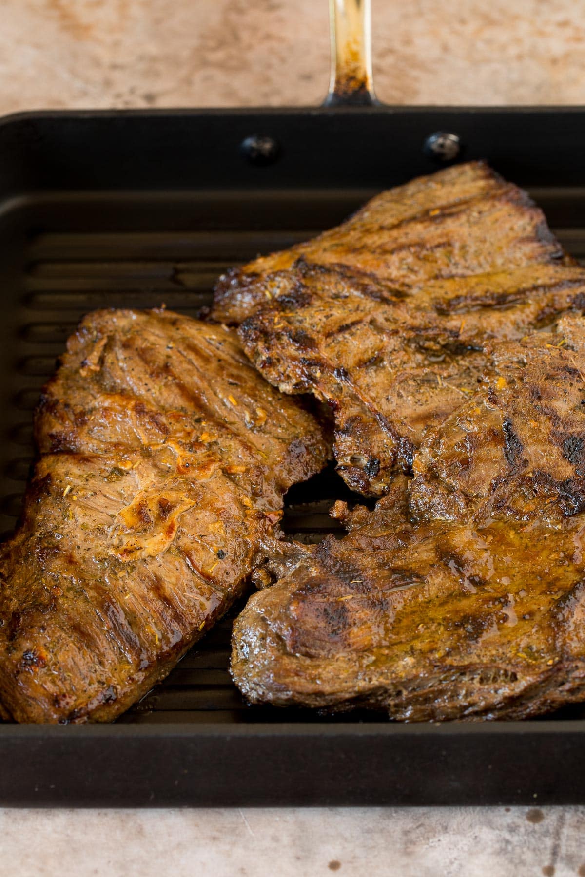 Cooked skirt steak in a grill pan.