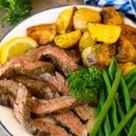 Steak coated in skirt steak marinade, sliced and served with potatoes and green beans.