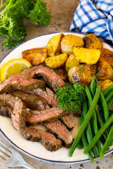 Steak coated in skirt steak marinade, sliced and served with potatoes and green beans.