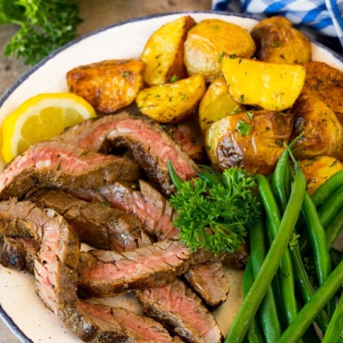 Steak coated in skirt steak marinade, sliced and served with potatoes and green beans.