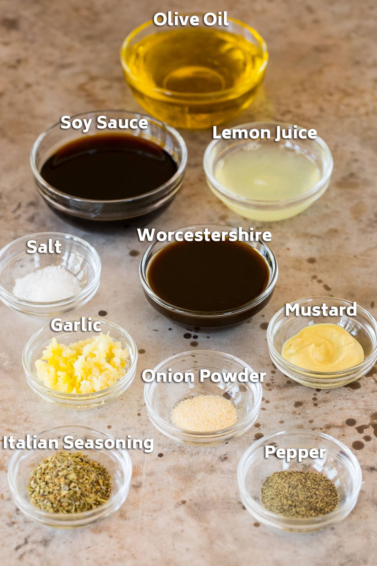 Bowls of ingredients including olive oil, soy sauce, lemon juice, herbs and spices.