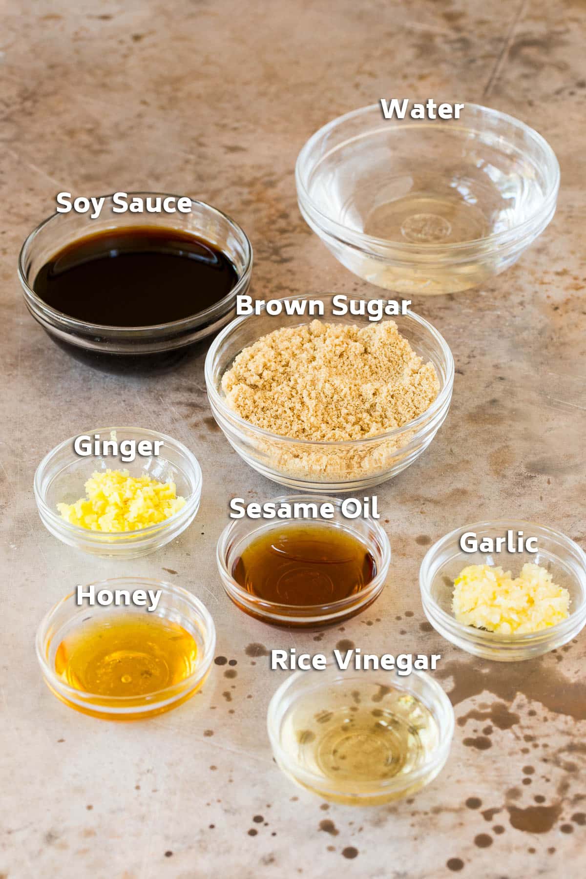 Bowls of ingredients including brown sugar, soy sauce, garlic and ginger.
