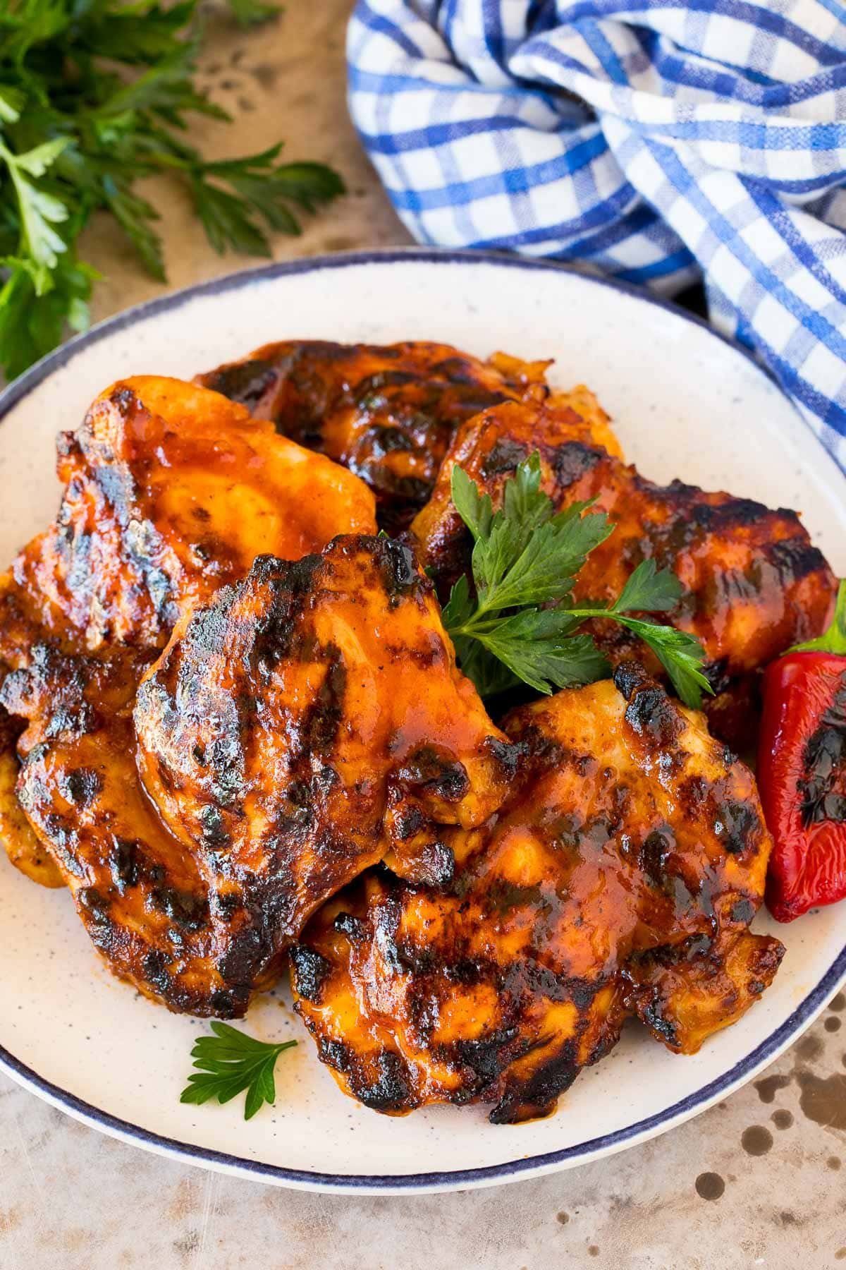 BBQ chicken marinade on chicken thighs that have been grilled and are on a platter.