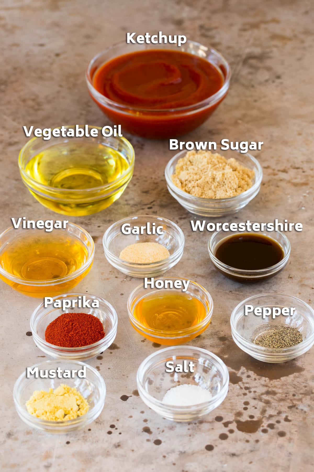 Bowls of ingredients including ketchup, vegetable oil, spices and seasonings.