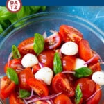 This tomato salad recipe is ripe tomatoes, fresh basil, mozzarella cheese and red onions, all tossed together in a zesty garlic and herb dressing.
