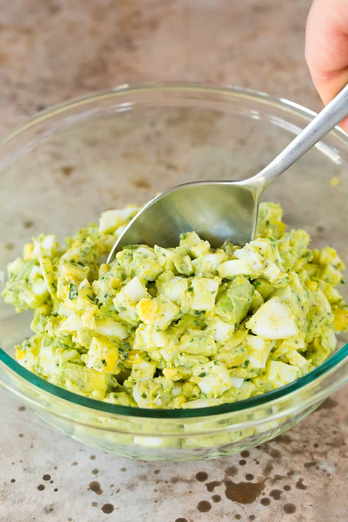 Eggs in a bowl with an avocado mayonnaise mixture.