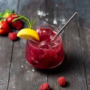 An image of a berry vodka smash cocktail in a glass.