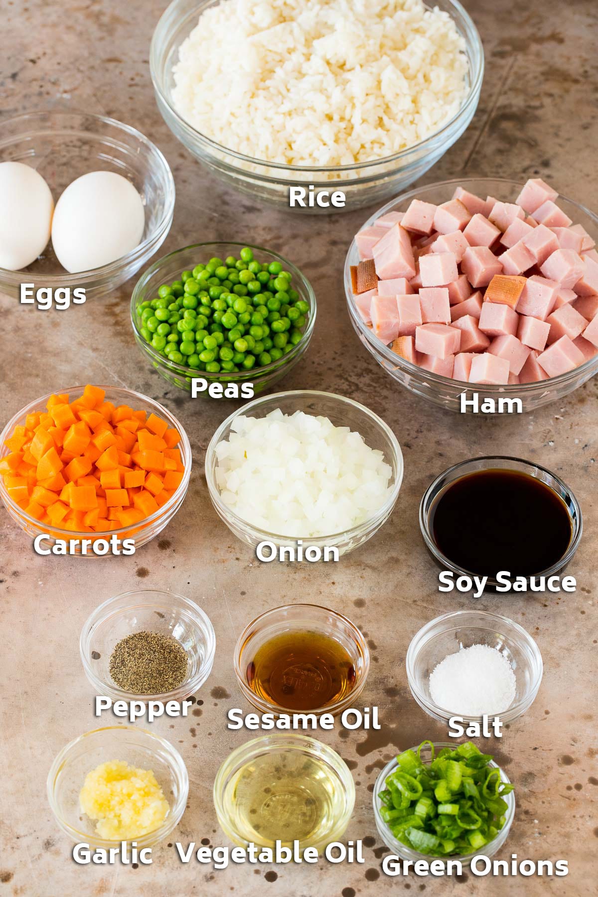 Bowls of ingredients including ham, rice, vegetables and seasonings.