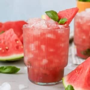 A glass of a watermelon basil cocktail.