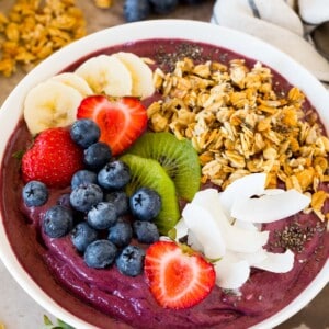 An acai bowl topped with fruit, granola and coconut.