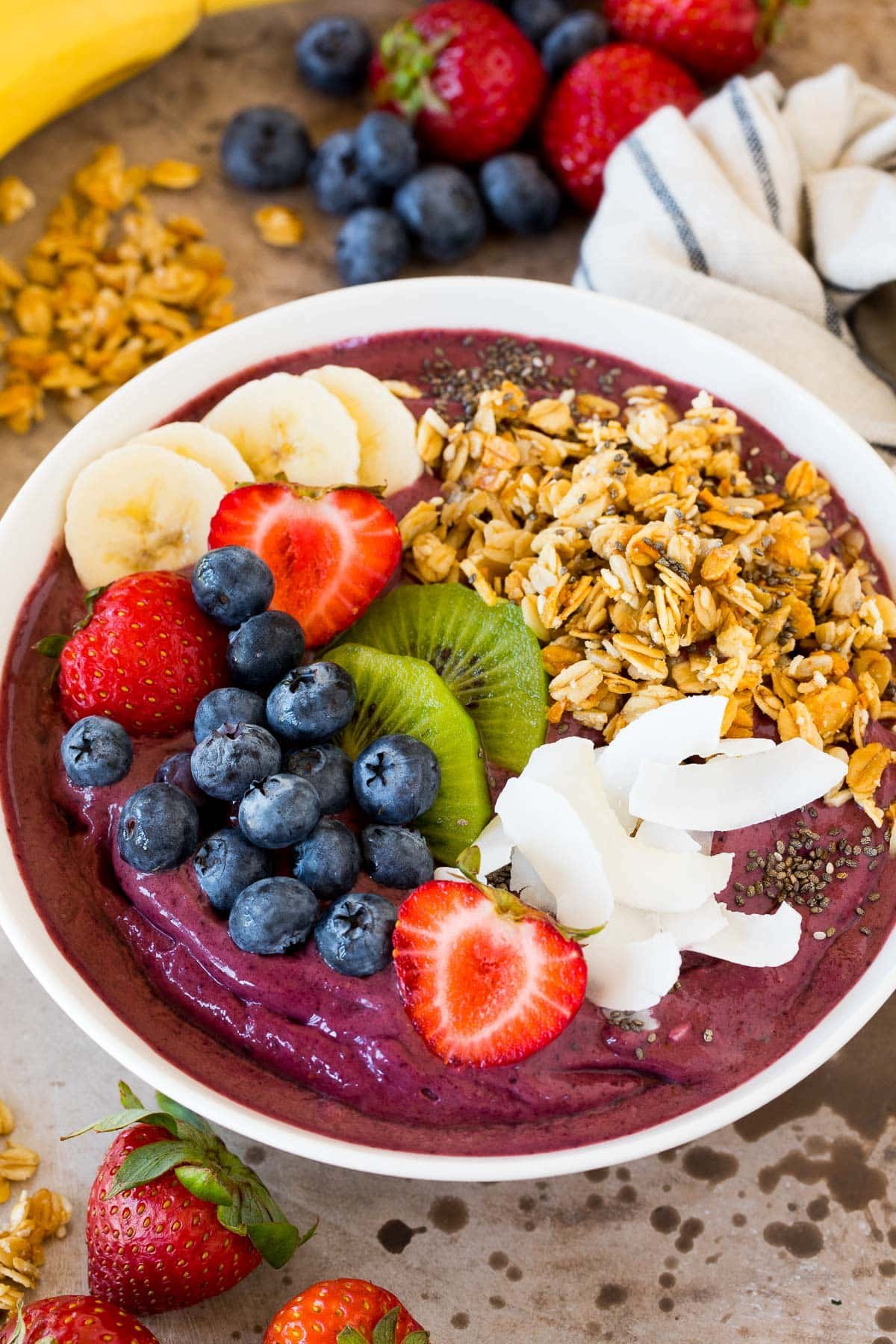 An acai bowl topped with fruit, granola and coconut.