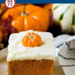 A slice of pumpkin cake on a small plate with fall decorations.